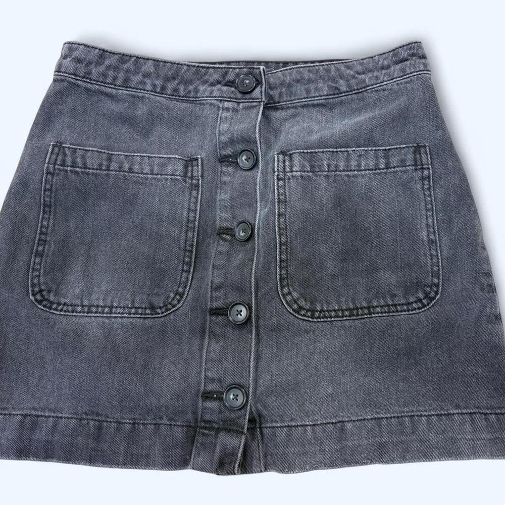 Free people black denim mini skirt with button front and pockets. Size: 27"